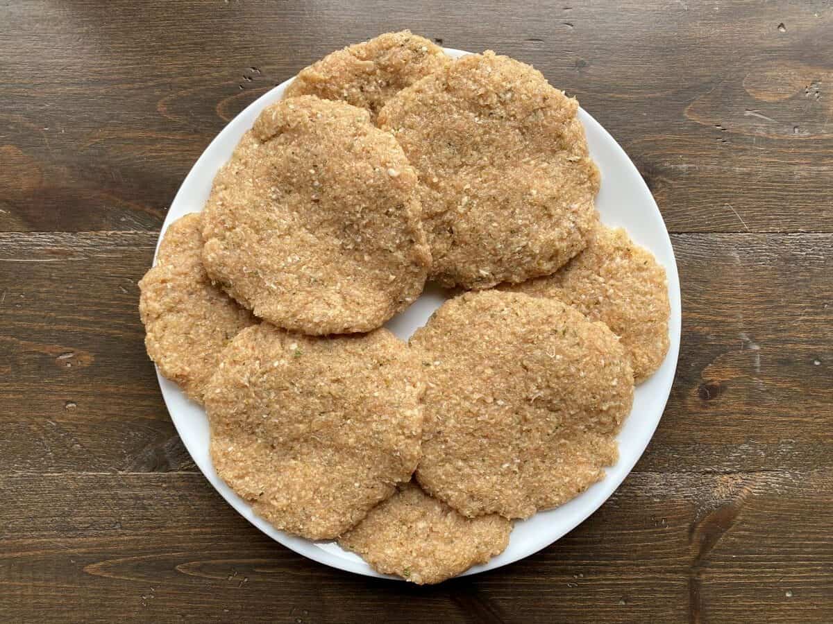Ground chicken patties on a plate.