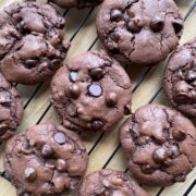 Double Chocolate Chip Cookies on a black cooling rack.
