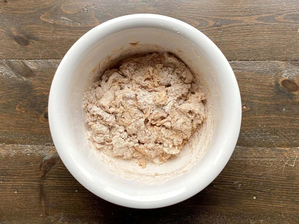 Shaggy dough in a large white bowl.