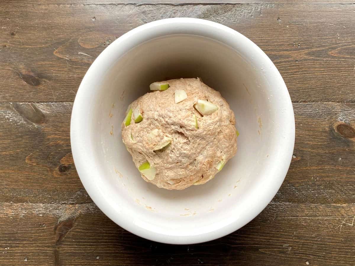 Dough ball in a large white bowl.